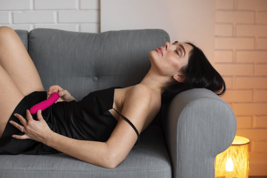 side view woman posing with vibrator